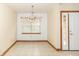 Clean and bright dining area with tile floors, natural light, and access to an exterior door at 4725 W Harrisburg Ct, New Palestine, IN 46163