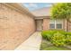 Inviting front entrance with a brick facade, manicured bushes, and a pathway leading to the front door at 4725 W Harrisburg Ct, New Palestine, IN 46163
