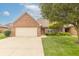Charming brick home with an attached two-car garage and a well-maintained front yard at 4725 W Harrisburg Ct, New Palestine, IN 46163