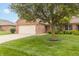 Beautiful brick home featuring a lush green lawn, mature trees, and a cozy front entryway at 4725 W Harrisburg Ct, New Palestine, IN 46163