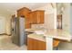 Well-appointed kitchen featuring a stainless steel refrigerator and open counter space at 4725 W Harrisburg Ct, New Palestine, IN 46163