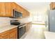 Bright kitchen features stainless steel appliances and plenty of cabinet storage at 4725 W Harrisburg Ct, New Palestine, IN 46163