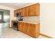 Well-lit kitchen with wooden cabinetry, modern appliances, and a smooth transition to the next room at 4725 W Harrisburg Ct, New Palestine, IN 46163