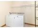 Well-lit laundry room with washer, dryer, wire shelving and neutral walls at 4725 W Harrisburg Ct, New Palestine, IN 46163