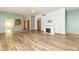 Bright open floor plan living room with fireplace and view into the kitchen at 4725 W Harrisburg Ct, New Palestine, IN 46163