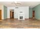 The living room boasts a fireplace, hard surface flooring and neutral color walls at 4725 W Harrisburg Ct, New Palestine, IN 46163