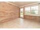 Bright sunroom features brick accent wall, tile floor, and large windows overlooking the manicured backyard at 4725 W Harrisburg Ct, New Palestine, IN 46163