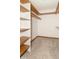 Walk-in closet featuring carpet flooring, white walls, and built-in wooden shelves at 4725 W Harrisburg Ct, New Palestine, IN 46163