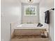 Bathroom featuring soaking tub, tile surround and window at 4808 Lakeview Dr, Greenwood, IN 46143