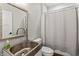 Bathroom with stainless steel sink, toilet and shower with gray curtain at 4808 Lakeview Dr, Greenwood, IN 46143