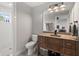 Bathroom featuring a window in the shower, a wood vanity, and a view into the bedroom at 4808 Lakeview Dr, Greenwood, IN 46143