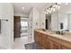 Bathroom featuring double vanity, sconce lighting and barn door access to a carpeted nook at 4808 Lakeview Dr, Greenwood, IN 46143