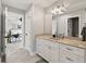 Bathroom with a double vanity and a view into the bedroom through an open door at 4808 Lakeview Dr, Greenwood, IN 46143