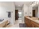 Bathroom featuring double vanity sinks, a soaking tub, and a sliding barn door at 4808 Lakeview Dr, Greenwood, IN 46143