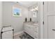 Bathroom featuring a single vanity, a window, and a small laundry basket at 4808 Lakeview Dr, Greenwood, IN 46143