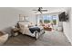 Bright bedroom featuring large windows, ceiling fan, and a comfortable seating area at 4808 Lakeview Dr, Greenwood, IN 46143