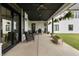 Spacious covered patio featuring multiple seating areas and stylish hanging plants at 4808 Lakeview Dr, Greenwood, IN 46143