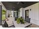 An outdoor living space with a black ceiling, stone fireplace and outdoor furniture at 4808 Lakeview Dr, Greenwood, IN 46143