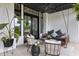 Relaxing covered porch with a swing, stylish seating, and decorative hanging plants at 4808 Lakeview Dr, Greenwood, IN 46143