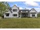 Charming white brick two-story home featuring black trim, black awnings, and a well-maintained lawn at 4808 Lakeview Dr, Greenwood, IN 46143