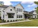 Beautiful white brick home featuring black trim, manicured landscaping, and a welcoming covered porch at 4808 Lakeview Dr, Greenwood, IN 46143