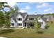 Two-story home featuring black trim, manicured landscaping, and a welcoming covered porch and outdoor seating at 4808 Lakeview Dr, Greenwood, IN 46143