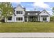 An inviting white two-story home boasts lush landscaping, a well-manicured lawn, and black-framed windows at 4808 Lakeview Dr, Greenwood, IN 46143