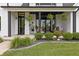Charming front porch with a porch swing, lush landscaping, and manicured lawn at 4808 Lakeview Dr, Greenwood, IN 46143