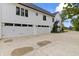 White three-car garage with a concrete driveway and meticulously landscaped entry to the home at 4808 Lakeview Dr, Greenwood, IN 46143