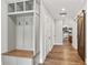 Hallway with a coat rack and bench, a sliding barn door, and hardwood floors at 4808 Lakeview Dr, Greenwood, IN 46143