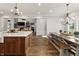 Open floorplan featuring the kitchen with an island and dining area with modern light fixtures at 4808 Lakeview Dr, Greenwood, IN 46143
