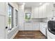 Bright laundry room with natural light, modern appliances, and white cabinets at 4808 Lakeview Dr, Greenwood, IN 46143