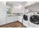 Well-lit laundry room featuring modern appliances and white cabinetry at 4808 Lakeview Dr, Greenwood, IN 46143