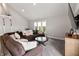 Open-concept living room featuring large sectional, loft access, and stylish decor at 4808 Lakeview Dr, Greenwood, IN 46143