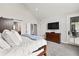 Main bedroom with a mounted TV, private balcony and barn door to the bathroom at 4808 Lakeview Dr, Greenwood, IN 46143