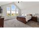 Main bedroom features vaulted ceiling, large windows, and a dark wood sleigh bed at 4808 Lakeview Dr, Greenwood, IN 46143