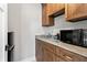 Functional mudroom with wood cabinets, sink, counter space, and modern microwave at 4808 Lakeview Dr, Greenwood, IN 46143