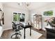 Bright office with hardwood floors, large windows and a bird cage at 4808 Lakeview Dr, Greenwood, IN 46143