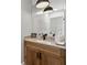 Stylish powder room with wood vanity, stone countertop, and modern fixtures at 4808 Lakeview Dr, Greenwood, IN 46143