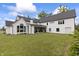 An aerial, rear exterior view shows the home's lawn and attached covered outdoor living area at 4808 Lakeview Dr, Greenwood, IN 46143