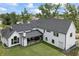 Expansive backyard featuring a covered patio, lush green lawn, and a seamless blend of indoor-outdoor living at 4808 Lakeview Dr, Greenwood, IN 46143