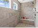 Shower with dual showerheads, built-in bench, and two windows providing natural light at 4808 Lakeview Dr, Greenwood, IN 46143