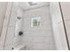 Shower featuring white tile surround and window with natural light at 4808 Lakeview Dr, Greenwood, IN 46143
