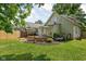 Well-maintained backyard with a deck, patio furniture, and a garden area at 4818 Winthrop Ave, Indianapolis, IN 46205