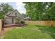 Spacious backyard featuring a well-maintained lawn and a charming wooden deck with patio furniture at 4818 Winthrop Ave, Indianapolis, IN 46205