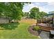 Landscaped backyard featuring a deck with seating and green lawn at 4818 Winthrop Ave, Indianapolis, IN 46205