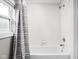 A clean bathroom with white tiled shower and shower curtain at 4818 Winthrop Ave, Indianapolis, IN 46205