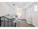 Bright bedroom with a daybed, white walls, and natural light from multiple windows at 4818 Winthrop Ave, Indianapolis, IN 46205