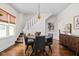 Bright dining room featuring hardwood floors, modern lighting, and staircase access at 4818 Winthrop Ave, Indianapolis, IN 46205