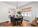 Cozy dining room with warm wood floors, natural light, and comfortable seating at 4818 Winthrop Ave, Indianapolis, IN 46205